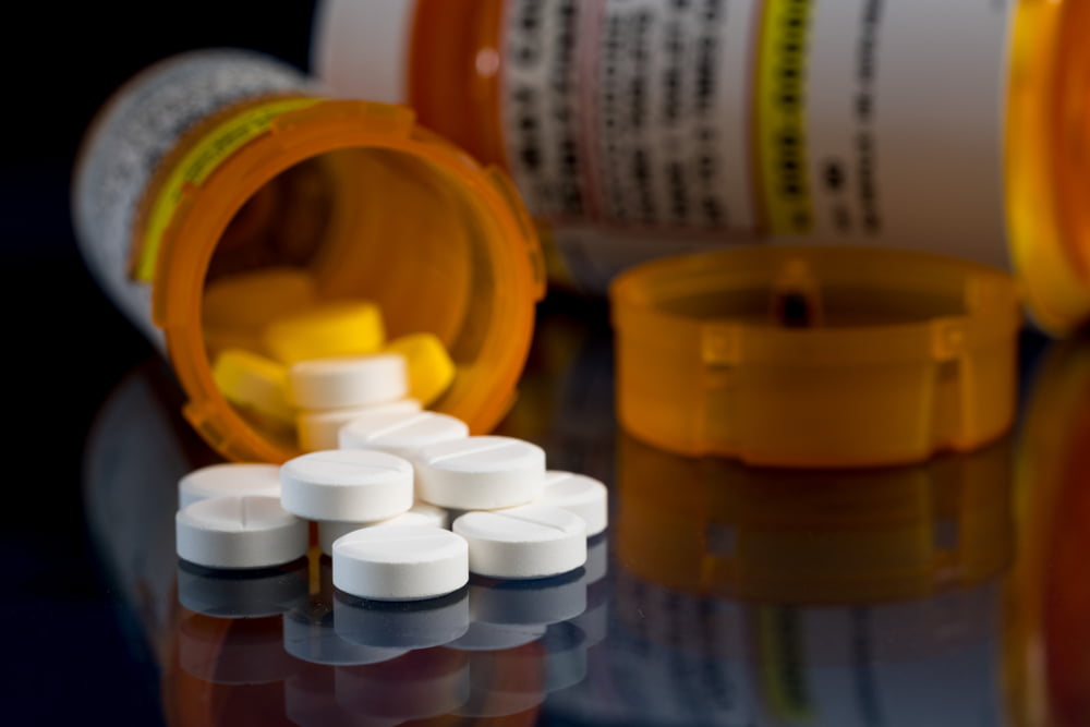 Fighting Prescription Drug Crimes in Vista and San Diego 1 A pill bottle with medication spread out to illustrate prescription drug crimes san diego
