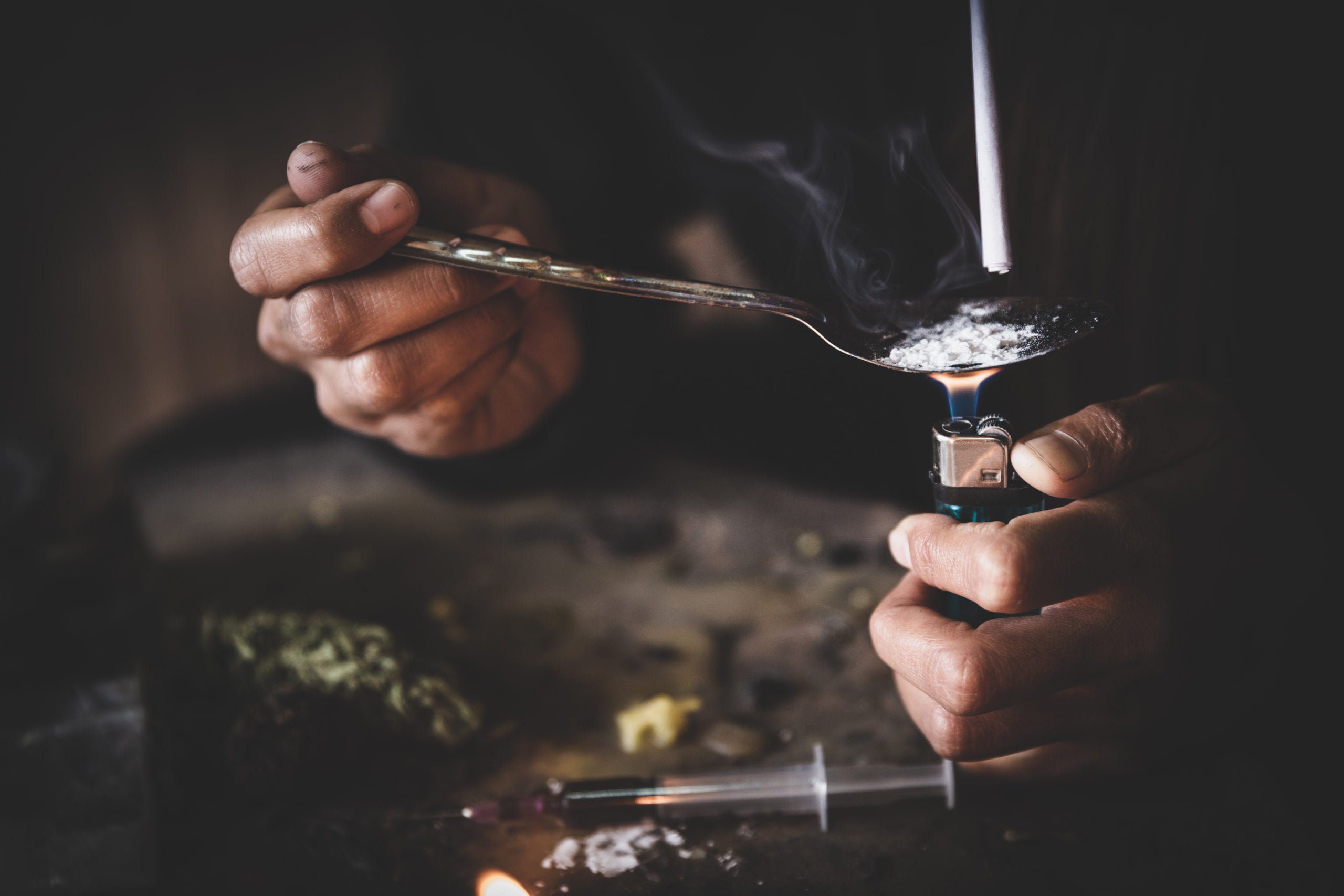 23152(c) (VC) Makes Driving While Addicted a Crime in San Diego 1 A person uses a lighter to cook heroin used to illustrate someone Driving While Addicted to Drugs