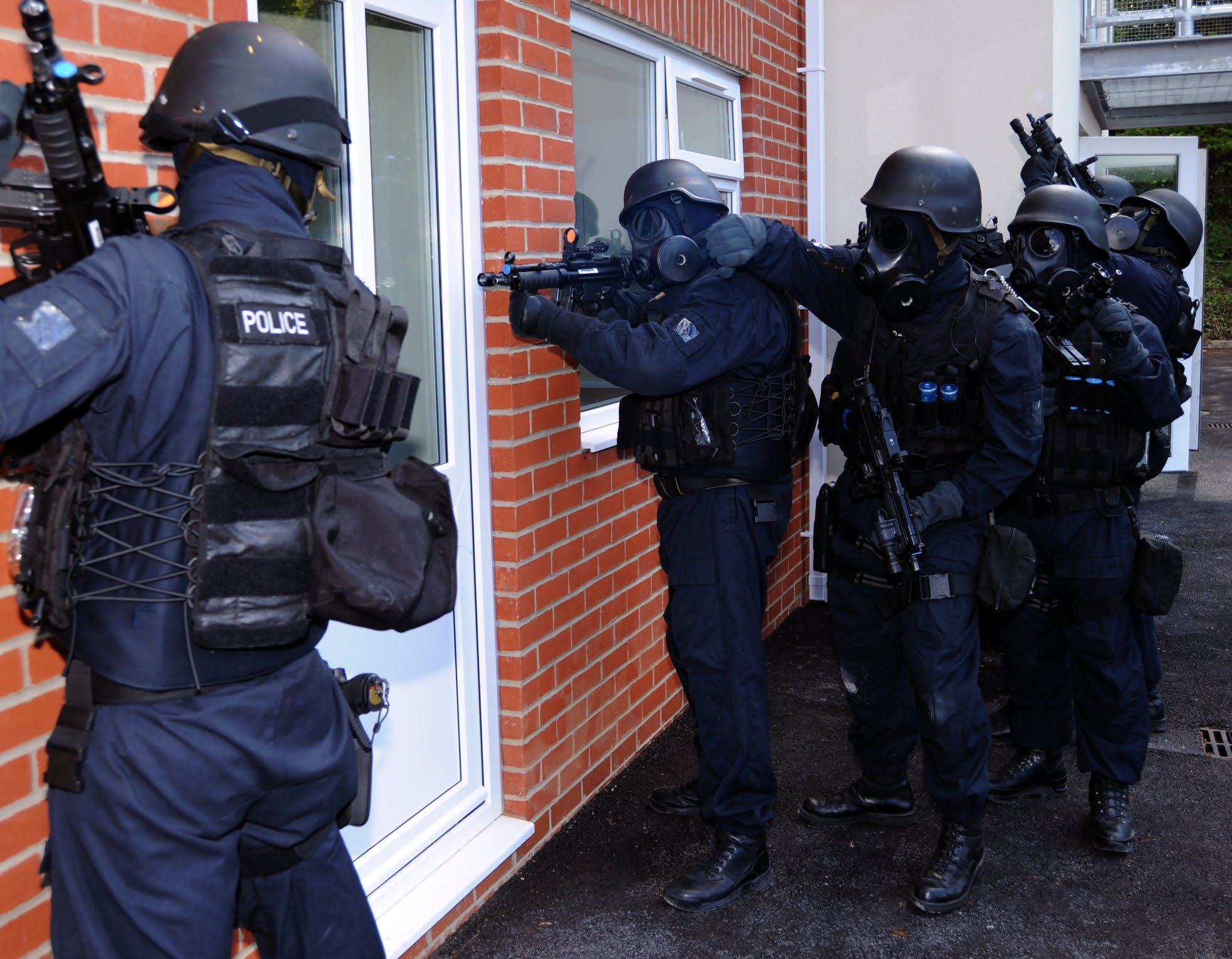 "Swatting" is the False Report of an Emergency 1 An armed police unit wait to enter a building used to illustrate swatting crimes under Vista, California law