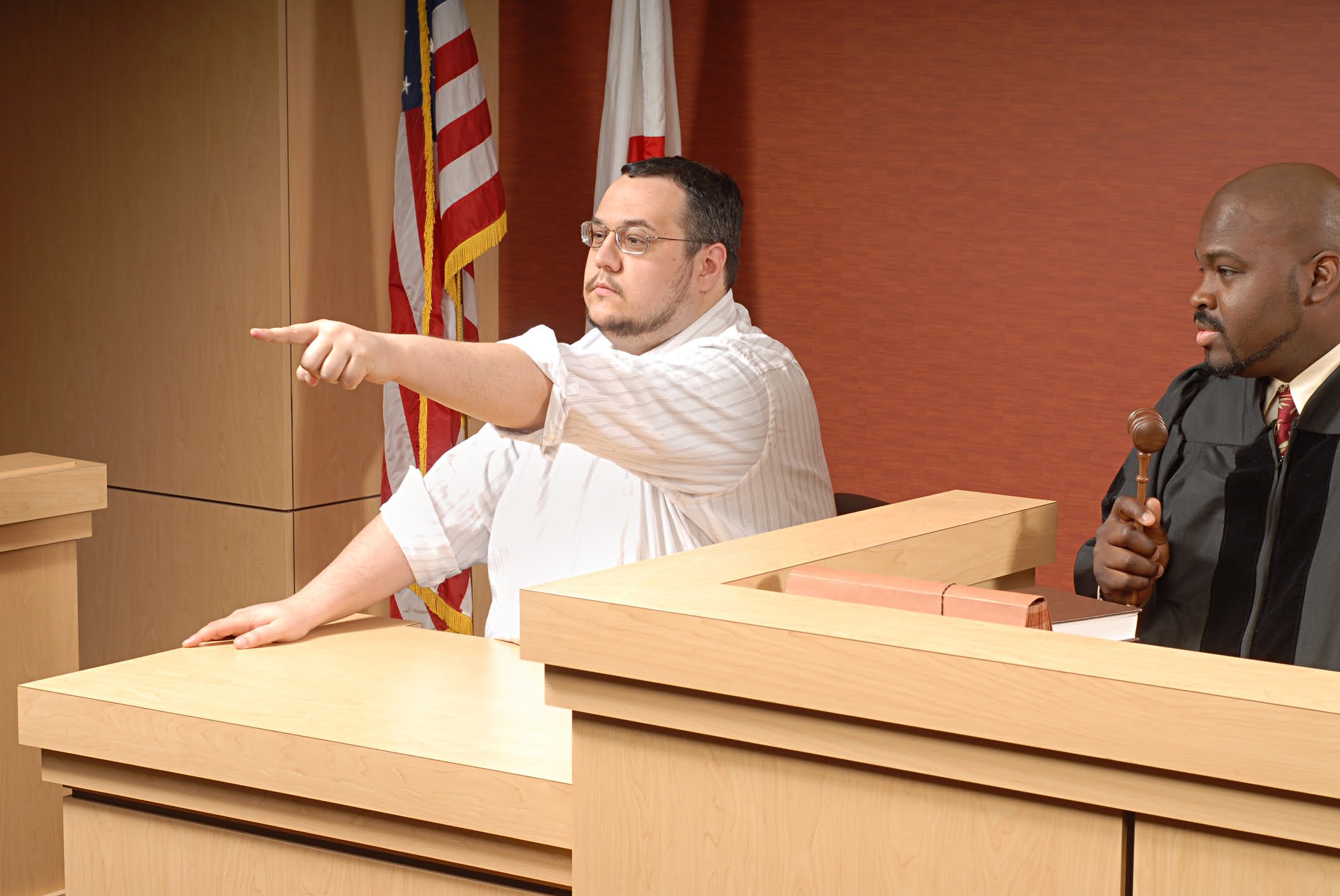 California Penal Code Section 118 (PC): Perjury Charges in Vista 1 A man pointing while testifying in court.