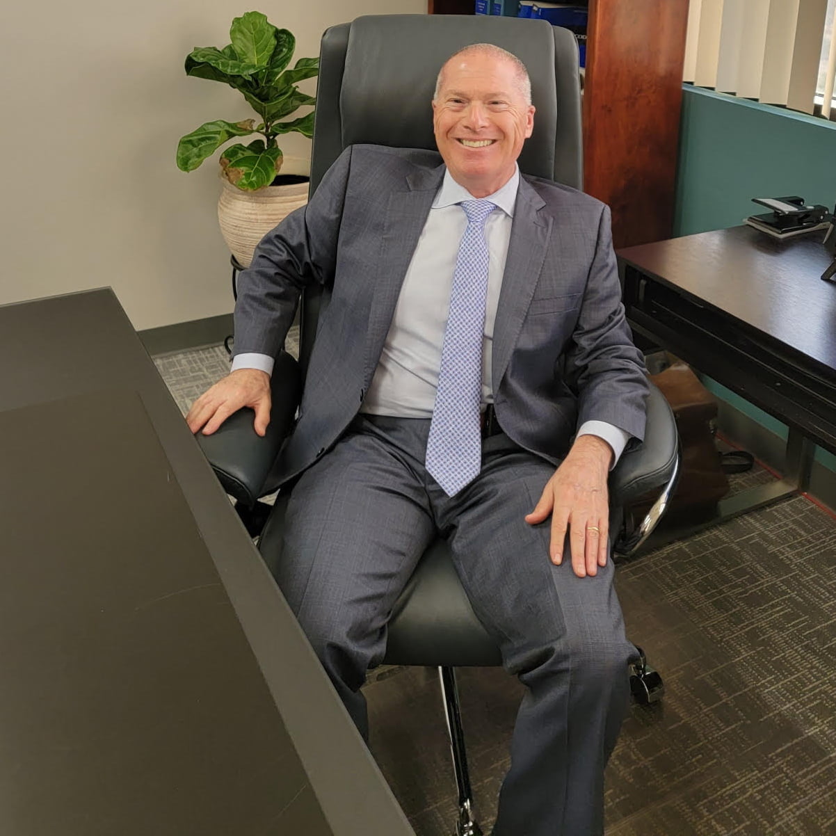 Peter Liss at his office desk, where he answers many questions for reporters