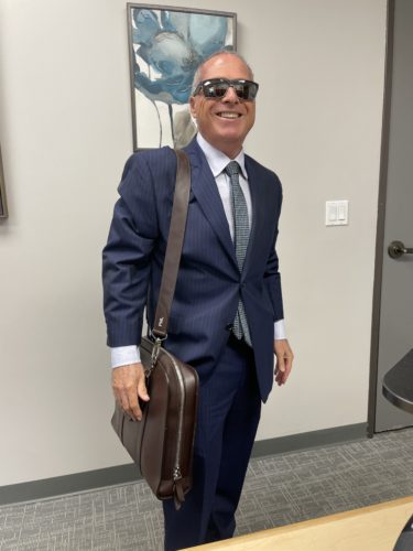 Peter Liss carrying a briefcase.